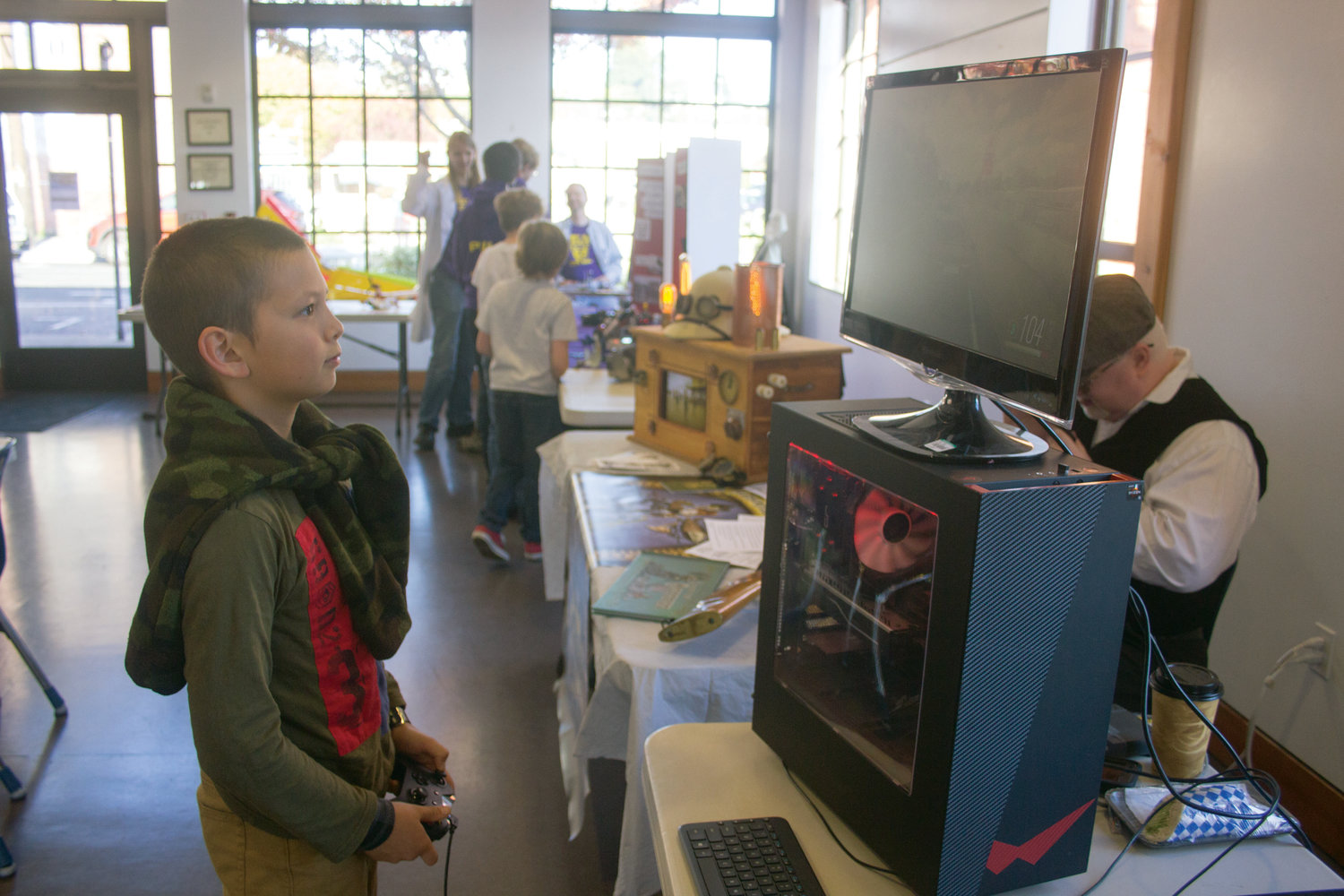 Liam Nezini of Quilcene played video games on Logan Flanagan’s computer at last year’s Mini Maker Fair.